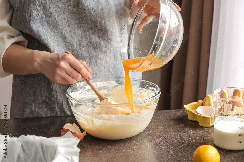Woman preparing tasty Basque burnt cheesecake in kitchen
