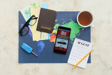 Poster - Mobile phone with open car rent app, passport, calendar, eyeglasses and cup of tea on light background