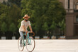 © Pixel-Shot - Handsome bearded man riding bicycle on city square