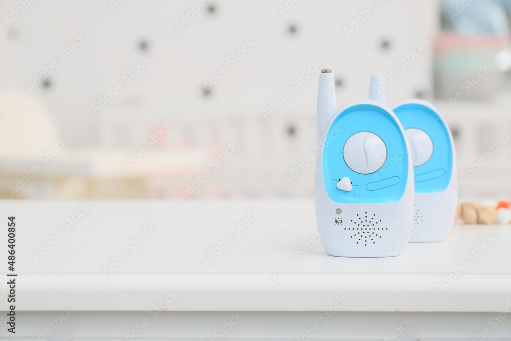 Modern baby monitors on table in room