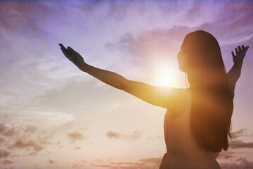 Young woman looking up feeling energized by the warm rays and sky