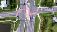 Drone Time Lapse Of Traffic Straight Down At The Intersection Of Floresta And Crosstown Parkway In Port Saint Lucie Florida. Cars And Trucks Moving Down Busy Street In South Florida Traffic Time Lapse