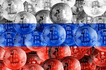 Holds a physical version of Bitcoin and the Russian flag. Conceptual image of cryptocurrencies and blockchain technology in Russia. Double exposure creative bitcoin symbol hologram. 