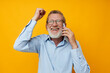 © Tatiana - old man talking on the phone emotions yellow background