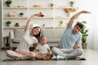 © Prostock-studio - Wellness Concept. Sporty Family With Little Baby Making Fitness Training At Home