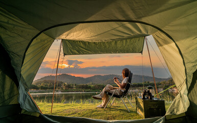 asian woman travel and camping alone at natural park in thailand. recreation and journey outdoor act