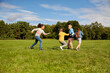 © Syda Productions - childhood, leisure and people concept - group of happy kids playing tag game and running at park