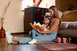 © Prostock-studio - Portrait of happy mother and daughter reading book