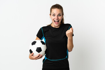 Wall Mural - Young football player woman isolated on white background celebrating a victory in winner position