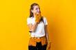 © luismolinero - Young electrician woman isolated on yellow background having doubts and with confuse face expression