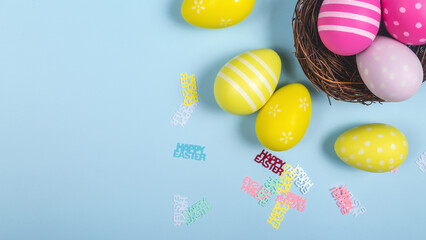  Happy easter banner. Blue Easter eggs in a nest on a pastel background