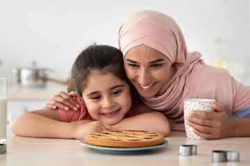 Wall Mural - Homemade Pastry. Happy Islamic Mom And Daughter Looking At Freshly Baked Pie