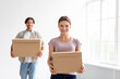 © Prostock-studio - Happy millennial european male and woman carry boxes with stuff, enjoy moving to new apartment