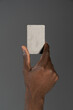 © Svyatoslav Lypynskyy - African american man hand holding debit or credit card in hand isolated on gray background. Financial business concept. Bank card in african man hand isolated on grey background