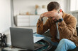 © Prostock-studio - Stressed Man At Laptop Touching Head Having Business Problems Indoor