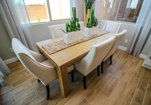 Dining Area Wooden Table With Six Chairs And Decorative Centerpieces