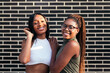 © Raul Mellado - young female friends smiling looking at camera