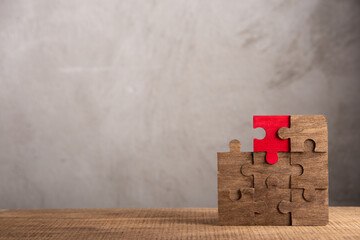 Creative idea and solve the problem concept. Teamwork success strategy - wooden puzzle on the grey background