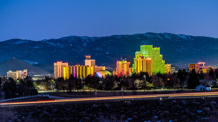 Wall Mural - City of Reno downtown Cityscape at dusk with light trails from the traffic on the street in front long exposure photograph.