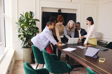 Multi ethnic mixed age range women in creative business meeting