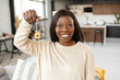 © Vadim Pastuh - Multiracial lady moving in new home or apartment. Overjoyed woman homeowner rejoicing in front of the camera and feeling great. Relocation concept
