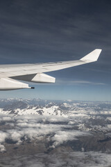 Sticker - A view of an airplane wing and snowy mountains