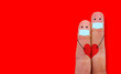 © Alex - Couple with masks are protecting themselves from the coronavirus covid-19. Fingers with heart.