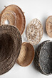 © Sergey Melnikov/Stocksy - Wicker baskets having on wall