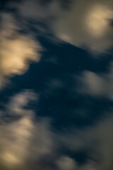 Wall Mural - night sky with stars and clouds, motion blur