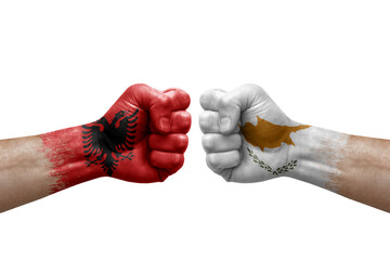 Two hands punch to each others on white background. Country flags painted fists, conflict crisis concept between albania and cyprus