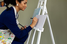 Happy Woman Painting On Sketchbook At Studio