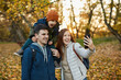 © Boris Jovanovic/Stocksy - Cheerful Family Taking Photos In A Park