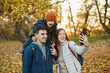 © Boris Jovanovic/Stocksy - Happy Family Taking A Selfie In A Park