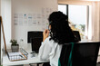© Valentina Barreto/Stocksy - Woman making calls with headset at office