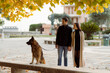© Mauro Grigollo/Stocksy - Happy lovers walk the dog in town