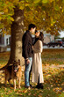 © Mauro Grigollo/Stocksy - Lovers at the city park with the dog