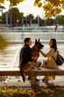 © Mauro Grigollo/Stocksy - Couple with the dog on a bench in town