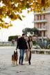 © Mauro Grigollo/Stocksy - Happy couple with the dog in town