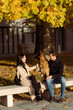 © Mauro Grigollo/Stocksy - Couple on a bench with their dog