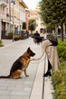 © Mauro Grigollo/Stocksy - Dog gives paw to a girl