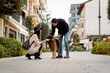 © Mauro Grigollo/Stocksy - Couple stroking their dog