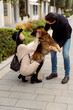 © Mauro Grigollo/Stocksy - Couple having fun with the dog outdoor