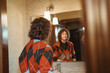 © Eloisa Ramos/Stocksy - Teenager in vintage outfit at bathroom