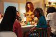 © BONNINSTUDIO/Stocksy - Woman talking with girlfriend during dinner