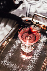 Wall Mural - pink sparkling wine drink with strawberry heart garnish on cocktail pick