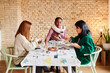 © Ivan Gener/Stocksy - Women dishing up Thanksgiving dinner