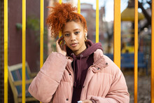Young Woman Standing Outside In Winter With Headphones