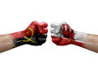 Two hands punch to each others on white background. Country flags painted fists, conflict crisis concept between angola and gibraltar