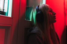 Female Listening To Music Under Neon Light