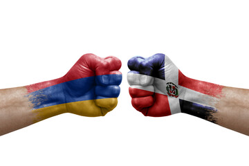 Two hands punch to each others on white background. Country flags painted fists, conflict crisis concept between armenia and dominican republic